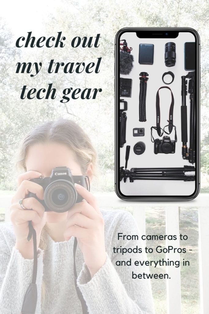 a girl holding a Canon M50 camera up to her eye with a phone with an image of a flat lay of multiple travel techs