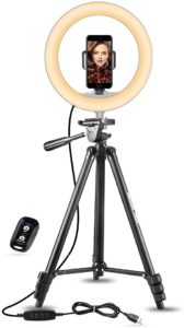 A ring light on a tripod demonstrating with a phone and remote.