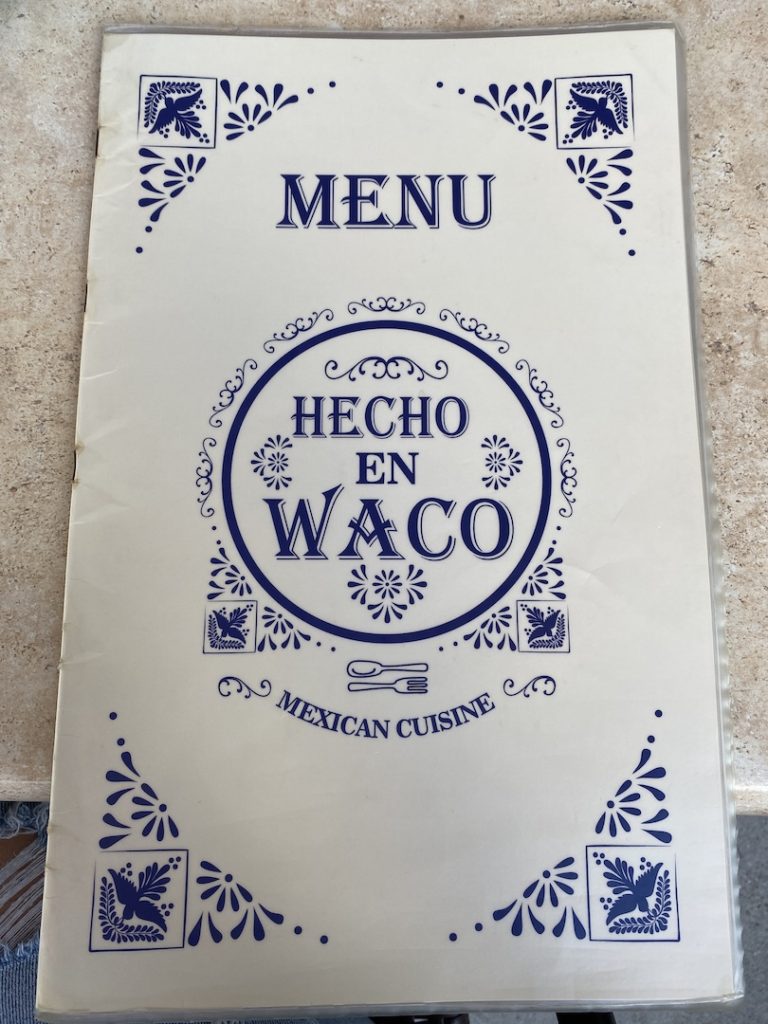 An image of the front of the menu for the restaurant Hecho en Waco.