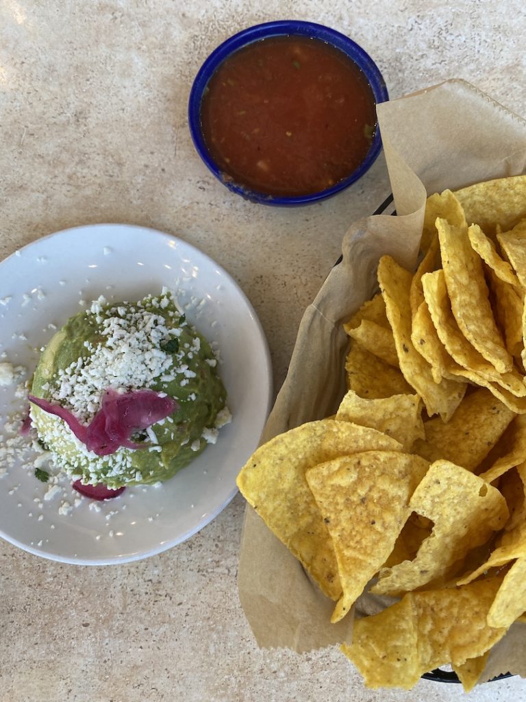 Aerial shot of some guacamole, chips, and salsa at the restaurant Hecho en Waco.