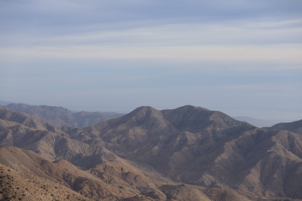 The viewpoint from Keys View at Joshua Tree National Park looking across a range of mountains.