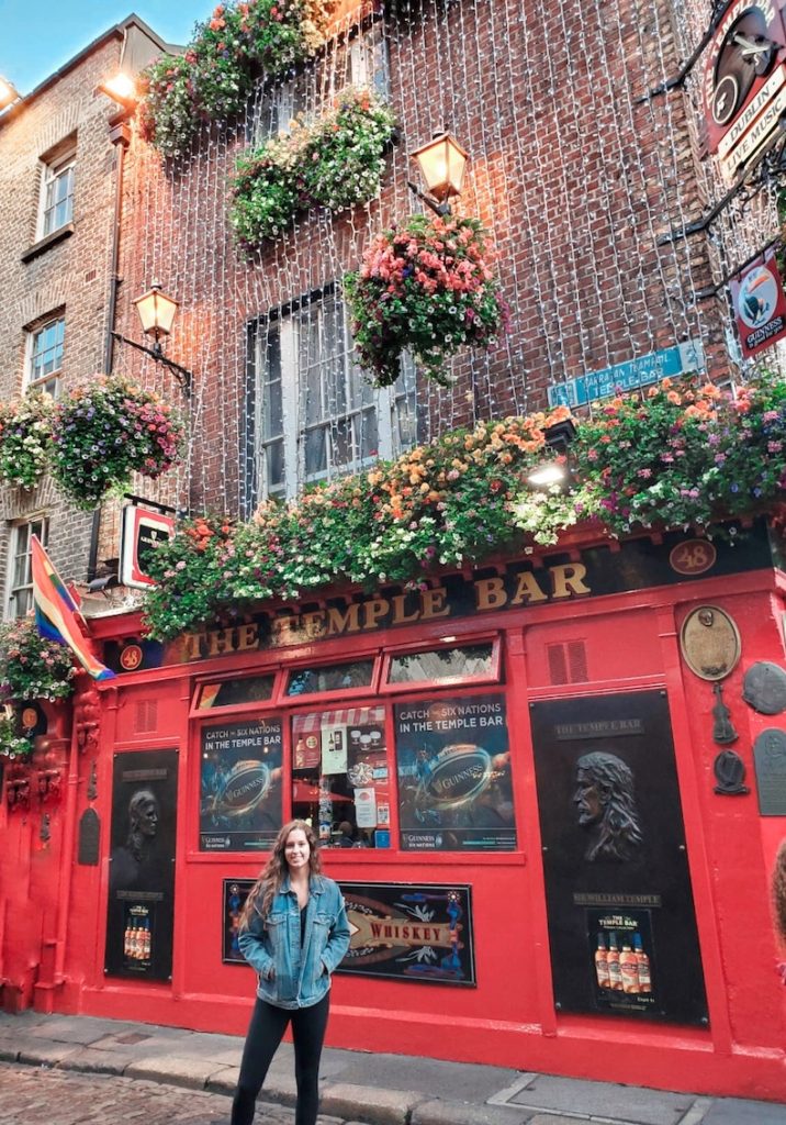 Me, Sarah, standing in front of the iconic Temple Bar in the hustle and bustle of Dublin.